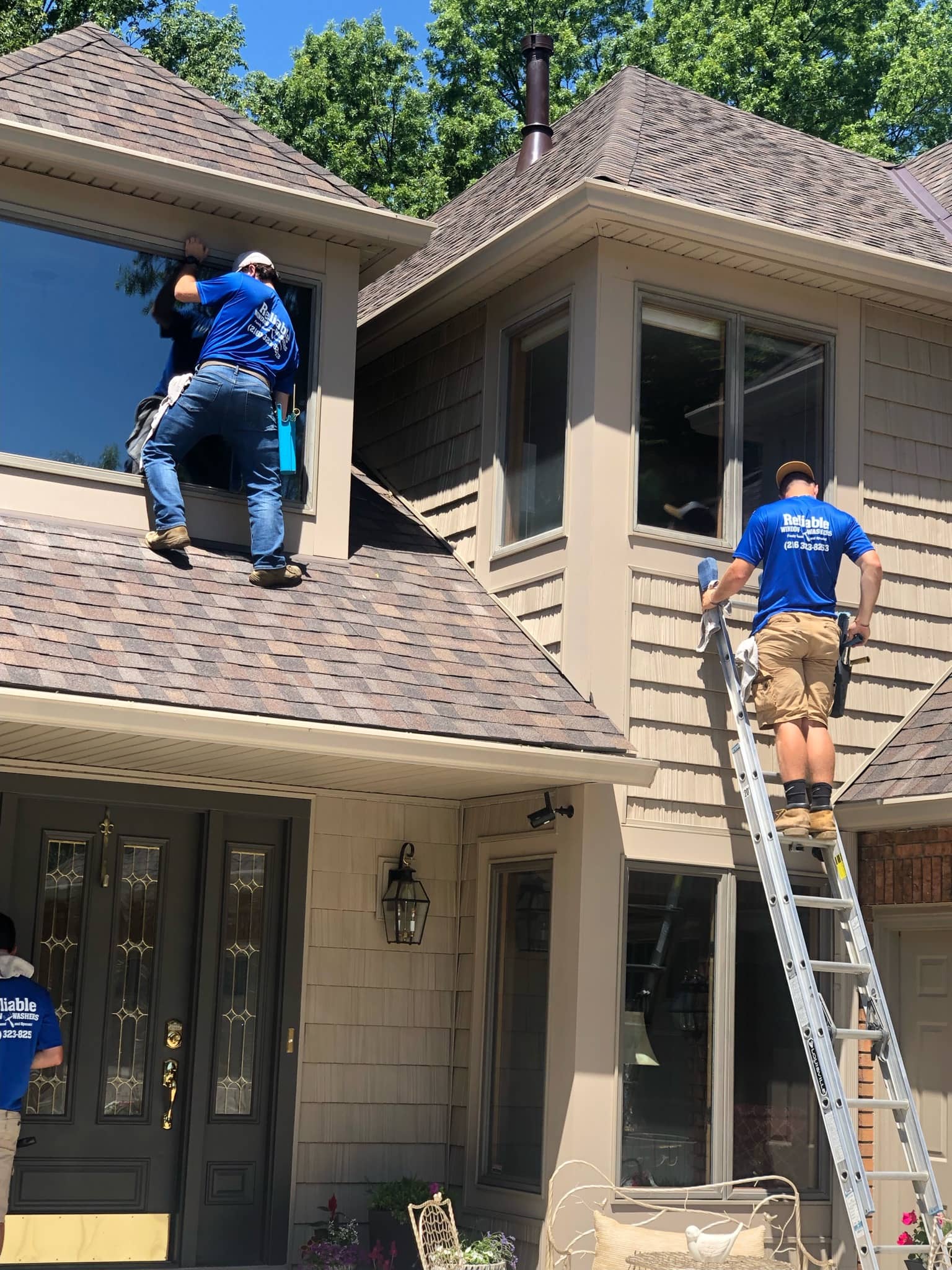 Reliable Window Washers crew working on residential property